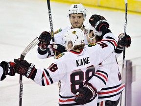 Chicago Blackhawks' Patrick Kane (88), Artem Anisimov (15) and Duncan Keith (2) celebrate a goal against the Edmonton Oilers during second period NHL action in Edmonton on Wednesday, Nov. 18, 2015.