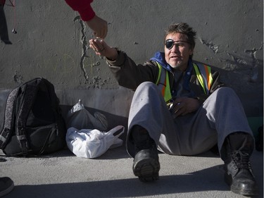 Bernie Jack, pan handles for money under the 9th Ave. N.W. bridge on 8th St. S.W. in Calgary, on November 22, 2015. Jack says he currently has a room to sleep in, but hasn't worked in years and considers himself a street person even though he has a roof over his head at night. Jack was also recently a victim of a brutal beating, to the point in which he had bones broken, had to have teeth removed, and he lost an eye and now wears a patch.