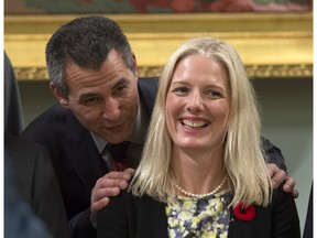 Hunter Tootoo, Minister of Fisheries, Oceans, and the Canadian Coast Guard speaks with Catherine McKenna, Minister of the Environment and Climate Change as they wait for a group photo, Wednesday Nov.4, 2015 in Ottawa.