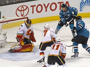 San Jose Sharks' Joel Ward, right, scores past Calgary Flames' Jonas Hiller during the second period of their game on Saturday night. San Jose won 5-2.