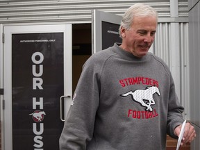 Calgary Stampeders GM John Hufnagel leaves the clubhouse at McMahon Stadium on Monday after passing the head coaching torch to Dave Dickenson.
