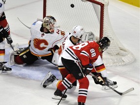 Calgary Flames goalie Karri Ramo misses a goal scored by Chicago Blackhawks' Patrick Kane — one of three Hawks tallies during a two-minute span in the second period on Sunday night.