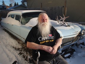 Kelly Jay, the former singer with iconic 70s Canadian rock band Crowbar, in his walker beside the Cadillac in his Penbrooke Meadows driveway on Wednesday, Nov. 25. The city is threatening to remove the Caddy and the band's tour bus from his backyard.