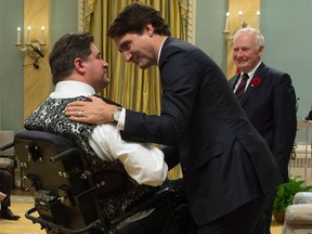 Prime Minister Justin Trudeau congratulates Kent Hehr as he is sworn in as Minister of Veterans Affairs and Associate Minister of National Defence during a ceremony at Rideau Hall in Ottawa on Wednesday, Nov. 4, 2015.
