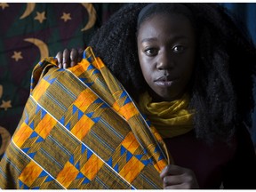 Makambe Simamba, a Zambian born artist, poses in her home studio in Calgary, on November 20, 2015, holding and surrounded by chitenges, which are East African fabric similar to a sarong and which are also the namesake of Simamba's one woman play, A Chitenge Story, which debut's in Calgary, on Sunday, Nov., 22, 2015. --  (Crystal Schick/Calgary Herald)