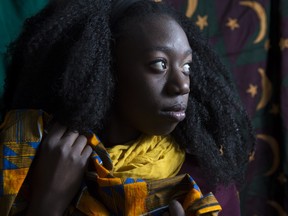 Makambe Simamba, a Zambian born artist, poses in her home studio in Calgary, on November 20, 2015, holding and surrounded by chitenges, which are East African fabric similar to a sarong and which are also the namesake of Simamba's one woman play, A Chitenge Story, which debut's in Calgary, on Sunday November 22, 2015.