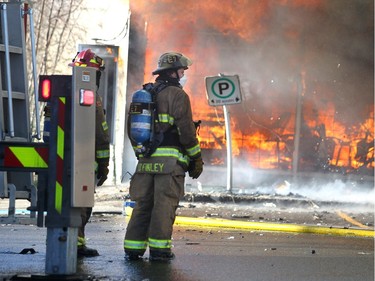 Members of the Calgary Fire Department watched as the Saigon Star Restaurant erupted into flames during a two alarm fire at the Stadium Shopping Centre on Nov. 12, 2015. At least four businesses were heavily damaged by fire while others in the mall sustained smoke and water damage.