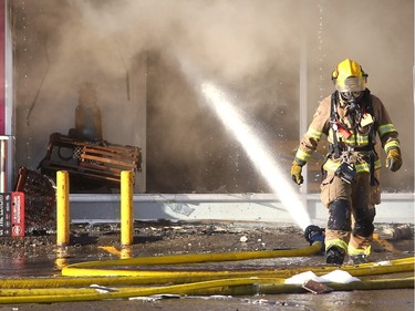 Members of the Calgary Fire Department worked to extinguish the flames in the Billingsgate Seafood Market as a two alarm fire spread through the Stadium Shopping Centre on Nov. 12, 2015. At least four businesses were heavily damaged by fire while others in the mall sustained smoke and water damage.