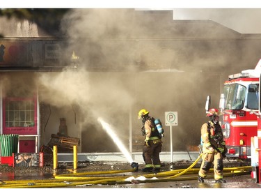 Members of the Calgary Fire Department worked to extinguish the flames in the Billingsgate Seafood Market as a two alarm fire spread through the Stadium Shopping Centre on Nov. 12, 2015.