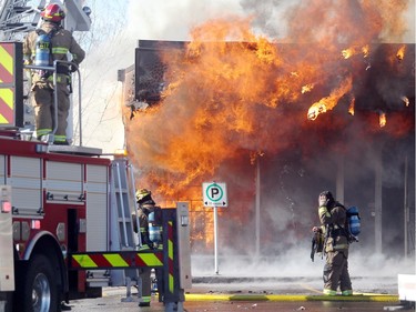 Members of the Calgary Fire Department watched as the Saigon Star Restaurant erupted into flames during a two alarm fire at the Stadium Shopping Centre on November 12, 2015. At least four businesses were heavily damaged by fire while others in the mall sustained smoke and water damage.