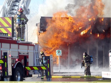 Members of the Calgary Fire Department watched as the Saigon Star Restaurant erupted into flames during a two alarm fire at the Stadium Shopping Centre on November 12, 2015. At least four businesses were heavily damaged by fire while others in the mall sustained smoke and water damage.