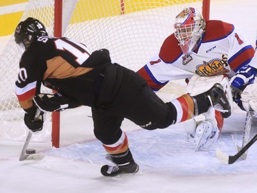 Calgary Hitmen forward Jakob Stukel just misses scooping the puck into the corner of the net as Edmonton Oil Kings goaltender Patrick Dea reaches across to block during WHL action at the Scotiabank Saddledome on Friday November 6, 2015.