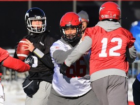 Calgary Stampeders quarterback Bo Levi Mitchell lines up a pass in front of new centre John Estes during team practice on Friday November 20, 2015.