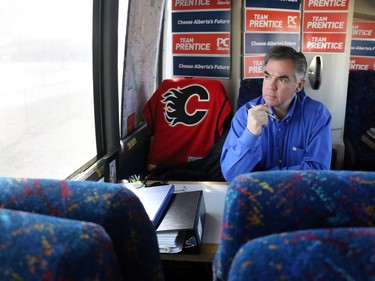 Premier Jim Prentice talked on the phone on his campaign bus en route to a campaign stop in Redcliff, Ab. on April 16, 2015.