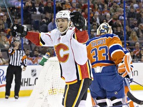 Calgary Flames' Michael Frolik  celebrates a goal on Edmonton Oilers' goalie Cam Talbot during the first period on Saturday. He added two more, including his late third-period seeing-eye game-winner.