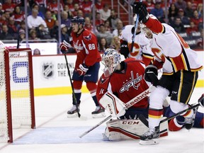 Calgary Flames right wing Michael Frolik (67), from the Czech Republic, celebrates his goal past Washington Capitals goalie Philipp Grubauer (31), from Germany, in the second period of an NHL hockey game, Friday, Nov. 13, 2015, in Washington.