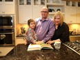 Nathan and Trina McKay with daughter Kenzie, 3 1/2 years, take in the kitchen at the Intrigue show home by Innovations by Jayman in Sunset Ridge, Cochrane.