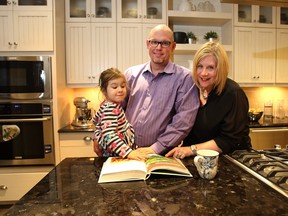 Nathan and Trina McKay with daughter Kenzie, 3 1/2 years, take in the kitchen at the Intrigue show home by Innovations by Jayman in Sunset Ridge, Cochrane.