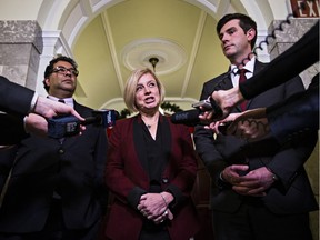 Premier Rachel Notley is flanked by Mayor Naheed Nenshi and his Edmonton counterpart Mayor Don Iveson after a meeting at the legislature on Nov. 18, 2015.