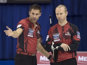 Calgary curler John Morris, seen discussing a shot with Team Canada skip Pat Simmons, right, at the men's world curling championship last April, loves the mixed doubles discipline. Curling Canada aims to win the first Olympic gold medal in the event when it is first staged in Pyeongchang 2018.