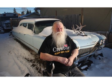 Kelly Jay, the former singer with iconic 70's Canadian rock band Crowbar, in his walker beside the Cadillac in his Penbrooke Meadows driveway  Wednesday November 25, 2015. The City is threatening to remove the Caddy and the band's tour bus from his backyard.