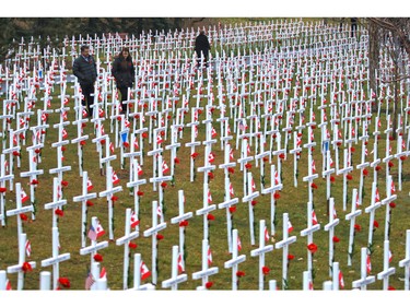 Calgarians walk through the Field of Crosses along Memorial Drive on Monday November 2, 2015. The annual memorial contains over 3200 crosses honouring southern Albertan's who died for Canada.