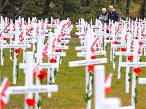 Debbie Henwood, right, and her mom Marion walk through the Field of Crosses along Memorial Drive. Reader  says soldiers' sacrifices have not only touched the lives of their friends and family, but have reached people they do not know and have never met.