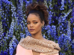 In this file photo, singer Rihanna poses before Christian Dior's Spring-Summer 2016 ready-to-wear fashion collection to be presented during the Paris Fashion Week, in Paris. On Monday, Rihanna announced her Anti World Tour, which will bring her to Calgary for an April, 2016 show.