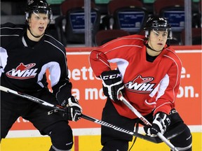 Calgary Hitmen defenceman Micheal Zipp, left, set up Jakob Stukel, right for a goal in the team's 4-2 win over the Prince Albert Raiders on Tuesday night.