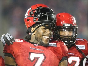 Aryn Toombs/Calgary Herald CALGARY, AB -- September 18, 2015 -- Calgary Stampeders player Junior Turner lets out a big smile after an intercept play that took the Stampeders to mere metres from a touchdown at McMahon Stadium in Calgary on Friday, Sept. 18, 2015. The Calgary Stampeders led the B.C. Lions, 18-3, at the end of the half in regular season play. (Aryn Toombs/Calgary Herald) (For Sports story by TBA) 00068465D SLUG: 0918 stampeders game
