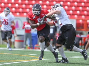 Stampeders defensive lineman Derek Wiggan, left, breaks away during a drill earlier this season. He is gaining more responsibility for the CFL club and could see increased action as starters rest against B.C. on Saturday.