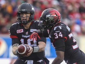 Calgary Stampeders quarterback Bo Levi Mitchell hands off to Tory Harrison during game action against the Saskatchewan Roughridres at McMahon Stadium on Saturday. The Stamps will host the B.C. Lions in the West semifinal on Nov. 15 after the Edmonton Eskimos clinched the bye.