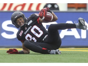 Calgary Stampeders Eric Rogers smiles as he hits the ground in the end zone to score at touchdown against the Saskatchewan Roughriders during game action at McMahon Stadium in Calgary, on October 31, 2015.
