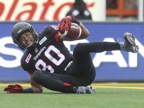 Calgary Stampeders Eric Rogers smiles as he hits the ground in the end zone to score at touchdown against the Saskatchewan Roughriders during game action at McMahon Stadium in Calgary, on October 31, 2015. --  (Crystal Schick/Calgary Herald) (For Sports story by  Rita Mingo) 00068726A
