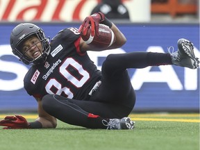 Calgary Stampeders Eric Rogers smiles as he hits the ground in the end zone to score at touchdown against the Saskatchewan Roughriders during game action at McMahon Stadium in Calgary, on October 31, 2015.