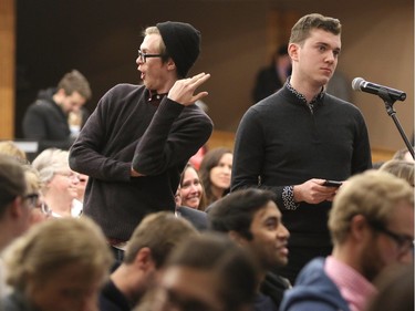 University of Calgary student Frank Finley, right, asks University president Elizabeth Cannon if she would resign during a town hall at the university on November 18, 2015.