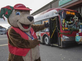 Calgary Transit Teddy helps encourage shoppers at Calgary Co-op West Springs to stuff a city bus full of non-perishable food items for the Calgary Food Bank in Calgary, on November 7, 2015.