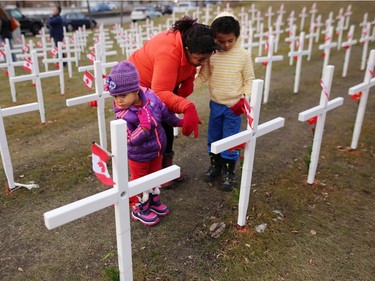 Aprylle Fraser and her children Sophie,3, left, and Aidan, 6, at the Field of Crosses during Remembrance Day.