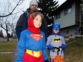 Symone, left, and Logan Ziegler trick or treat in the community of Beddington Heights in Calgary on Saturday, Oct. 31, 2015.