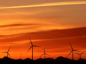 The suns sets behind a wind farm near Fort MacLeod.