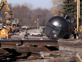 Workers tend to the scene of a train derailment in Watertown, Wis. Monday, Nov. 9, 2015, after a 13 cars of a Canadian Pacific train carrying crude oil overturned Sunday. One of the cars was punctured, spilling less than 1,000 gallons of oil. Thirteen of 110 cars derailed in Watertown Sunday afternoon, the second derailment in Wisconsin in as many days.