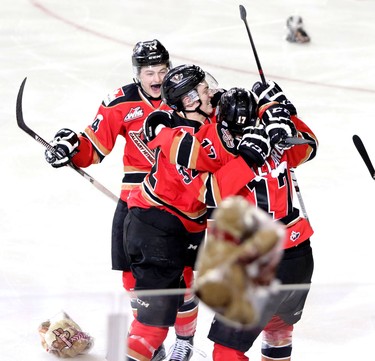 CALGARY.; DECEMBER 06, 2015  -- Calgary Hitmen Jordy Stallard, right, celebrates his goal on the Swift Current Broncos with teammates Travis Sanheim, middle and Layne Bensmiller during the annual Teddy Bear Toss at the Scotiabank Saddledome on December 6, 2015.
Photo by Leah Hennel, Calgary Herald 
(For Sports story by ?)