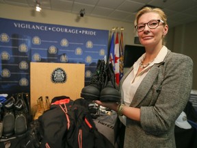 Const. Lara Sampson shows off some stolen items seized by police at Calgary Police Service headquarters.