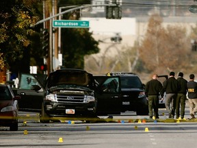 FBI agents and local law enforcement examine the crime scene where suspects of the Inland Regional Center were killed on December 3, 2015 in San Bernardino, California.