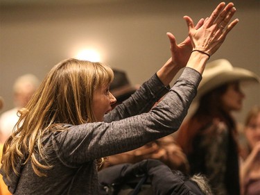 A woman raises her hands in anger at Alberta's Agriculture Minister Oneil Carlier during a consultation on Bill 6 at Westerner Park in Red Deer on Tuesday, Dec. 1, 2015.