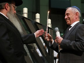 Rabbi Menachem M. Matusof and Avi Amir light the candles at the 27th Annual Community Menorah Lighting at Calgary City Hall on Monday night, Dec. 7, 2015.