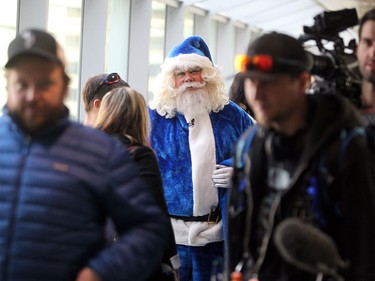 WestJet's Blue Santa made his way through the crowd at Pearson International Airport during a quick stop in Toronto following a trip up the CN Tower on Dec. 9, 2015 during the 12,000 Mini Miracle day.
