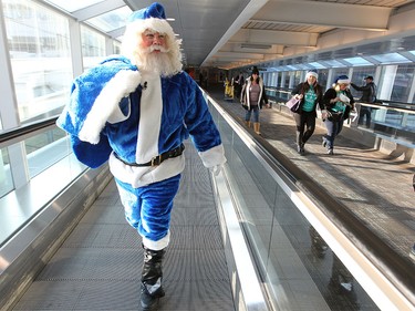 WestJet's Blue Santa made his way through the Pearson International Airport in Toronto, ON. where he made a trip up the CN Tower on Dec. 9, 2015 during the 12,000 Mini Miracle day.