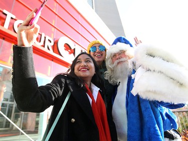 WestJet's Blue Santa took a selfie with Hamilton's Kinski Shabilla, left, and her mother Viksera after Blue Santa took them on a trip up the CN Tower on Dec. 9, 2015 during the 12,000 Mini Miracle day.