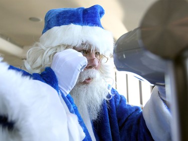 WestJet's Blue Santa looked through the telescope to get a good look at the Toronto, ON. area while visiting the CN Tower on Dec. 9, 2015 during the 12,000 Mini Miracle day.